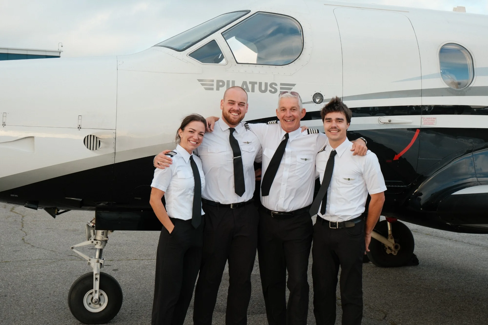 Tessa Forman, Jeremy Hall, Simon Hitchen and Alexis Dion, arm in arm in front of our Pilatus PC-12