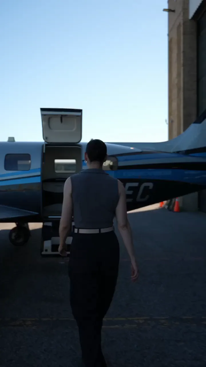 A NectAir guest walking up to our Piper Meridian and taking her seat